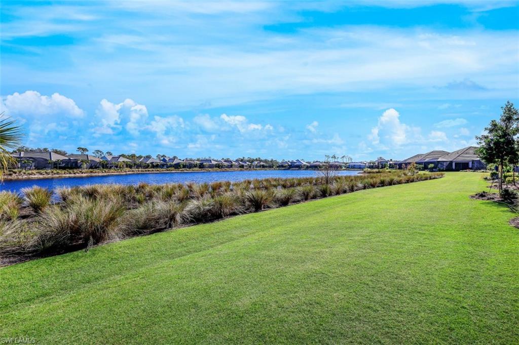 6295 Arriba Avenue Naples, FL 34113 - Photo 30 of 34 a view of a lake with houses in the back