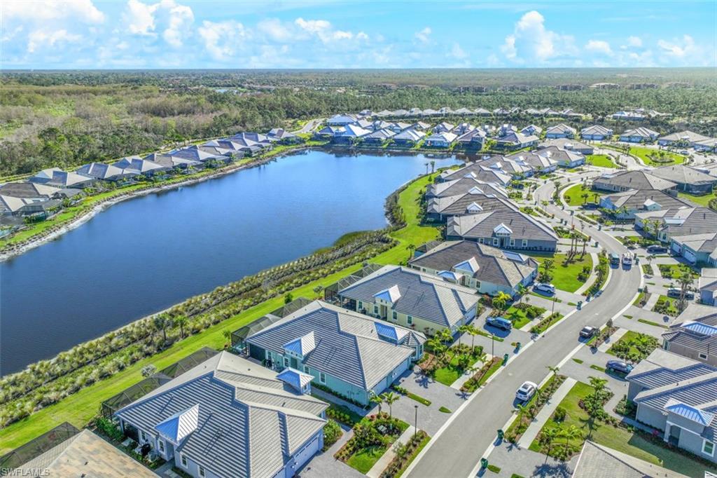 6295 Arriba Avenue Naples, FL 34113 - Photo 32 of 34 an aerial view of a house with a lake