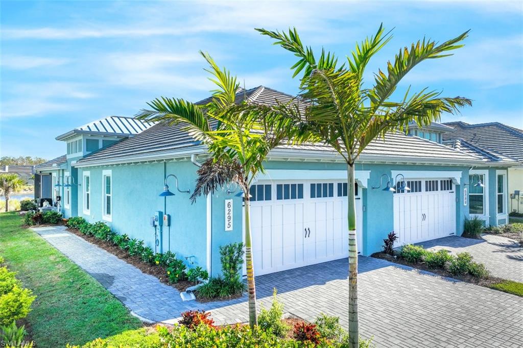 6295 Arriba Avenue Naples, FL 34113 - Photo 5 of 34 a front view of a house with a garden