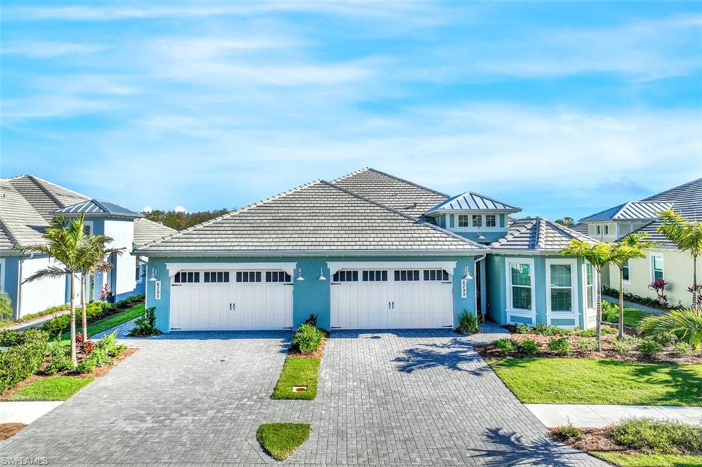 6295 Arriba Avenue Naples, FL 34113 - Photo 6 of 34 front view of a house with a garden