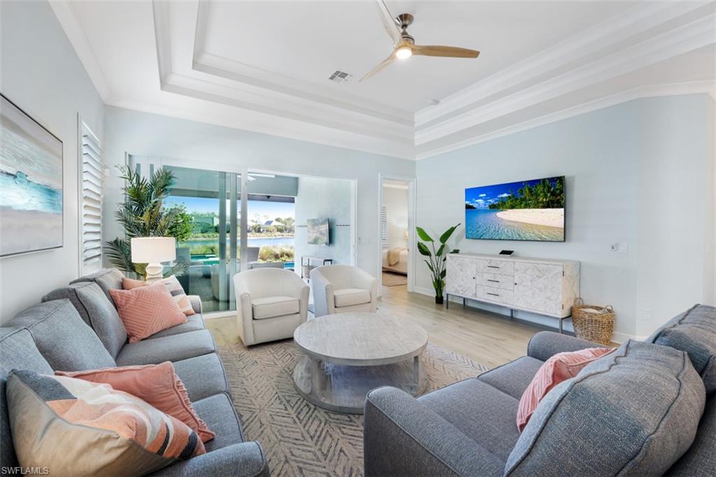 6295 Arriba Avenue Naples, FL 34113 - Photo 7 of 34 a living room with furniture and a large window