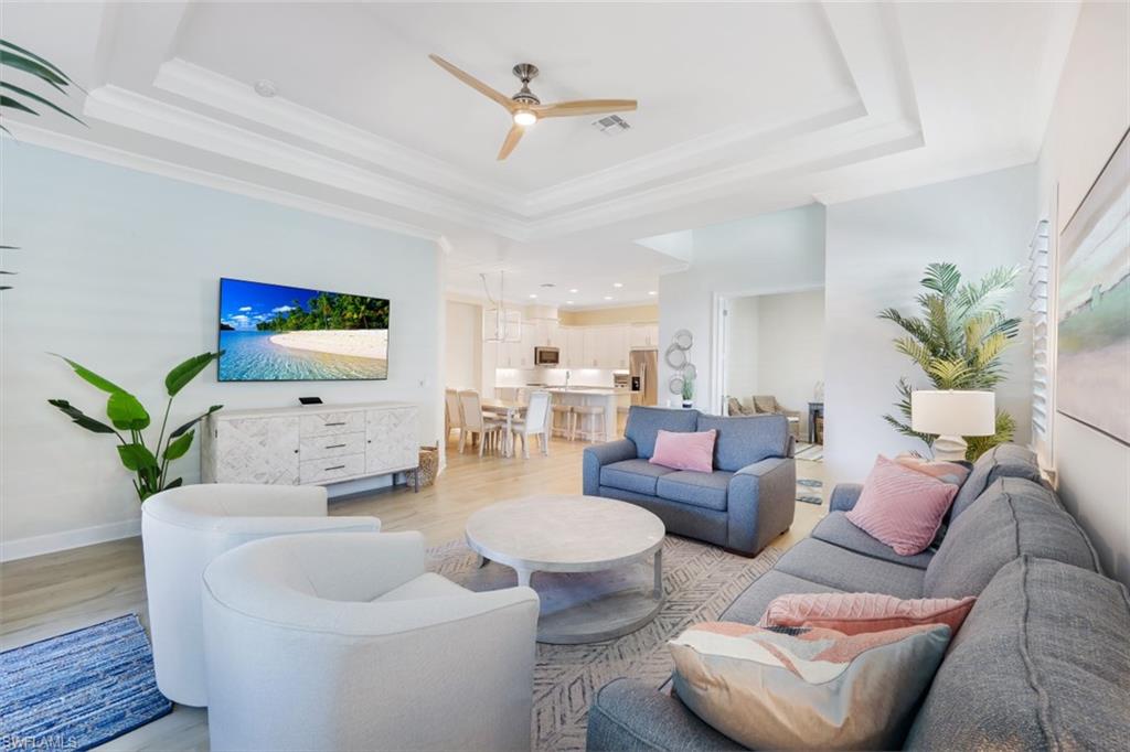 6295 Arriba Avenue Naples, FL 34113 - Photo 8 of 34 a living room with furniture and a chandelier