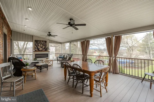 a kitchen with stainless steel appliances granite countertop a refrigerator a sink dishwasher a stove and a dining table with wooden floor