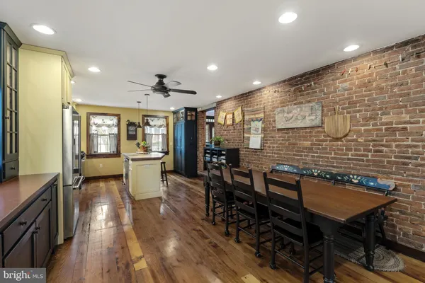 a living room with furniture ceiling fan and a window