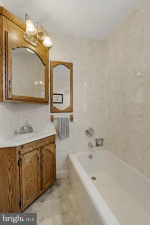 a bathroom with a sink a toilet a mirror and shower