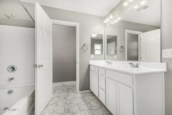 a bathroom with a sink a mirror and a bathtub