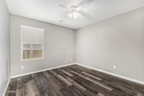 a view of a room with a ceiling fan and a window