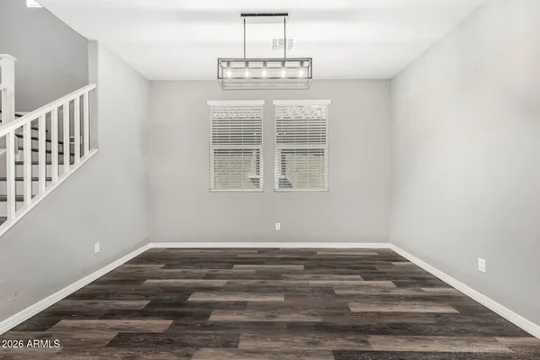 a view of wooden floor and windows in a room