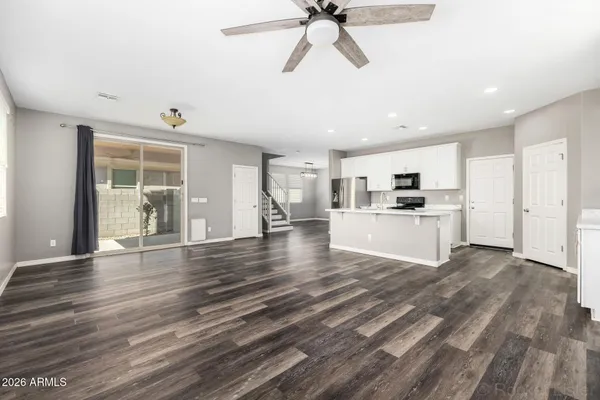 a view of a kitchen with a sink and dishwasher wooden floor