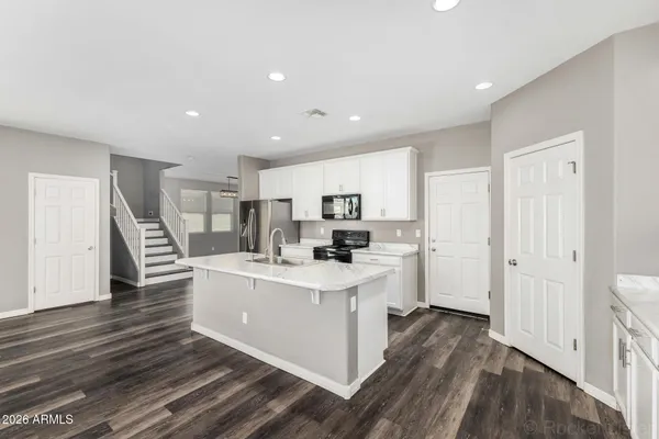 a view of kitchen with cabinets and wooden floor