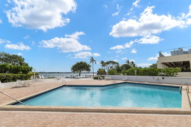 a view of a swimming pool with lounge chairs