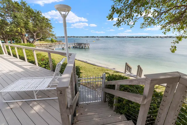 a view of a balcony with wooden floor and iron fence