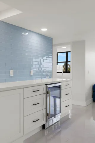 a kitchen with granite countertop white cabinets and appliances