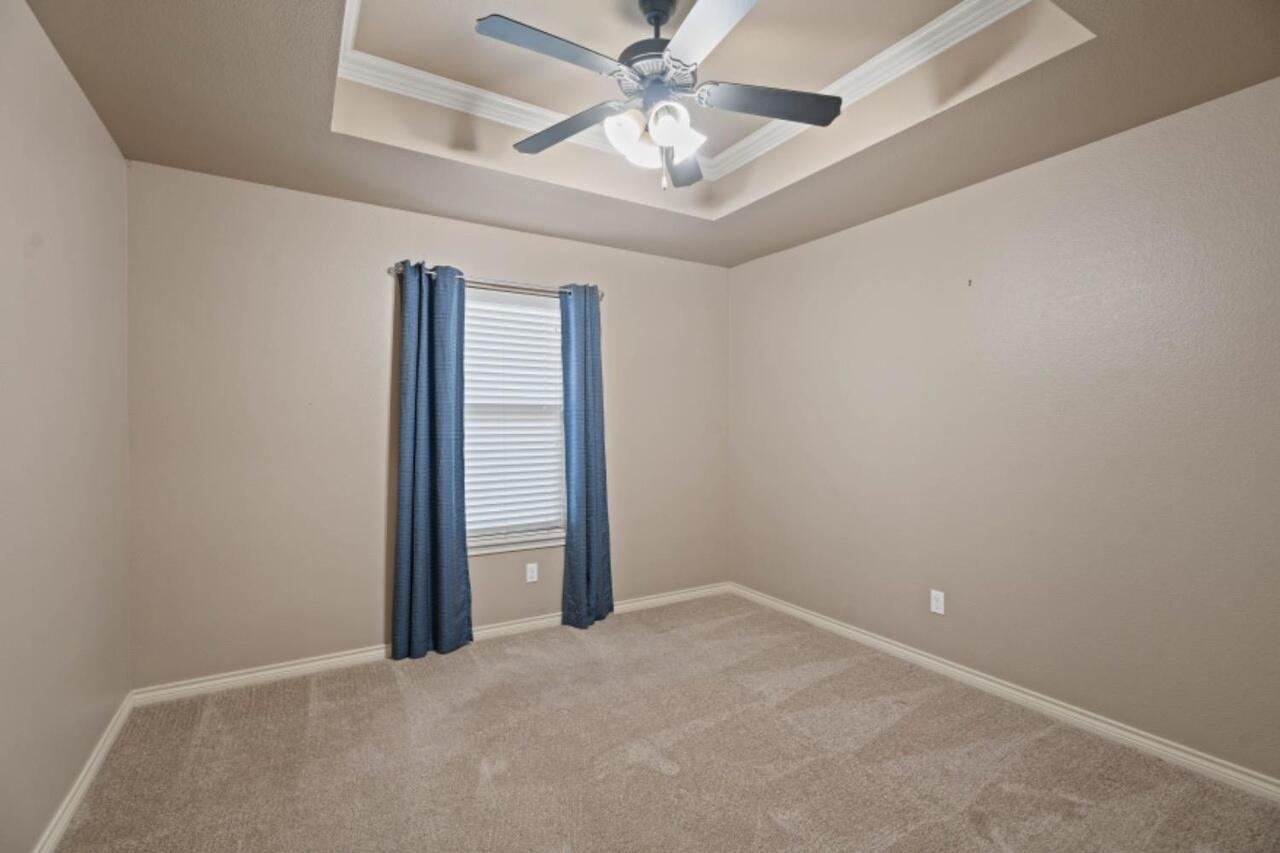 6112 101st Street Lubbock, TX 79424 - Photo 16 of 20 an empty room with a ceiling fan and closet
