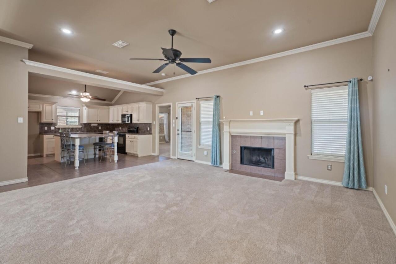 6112 101st Street Lubbock, TX 79424 - Photo 2 of 20 a view of a livingroom with furniture and a kitchen