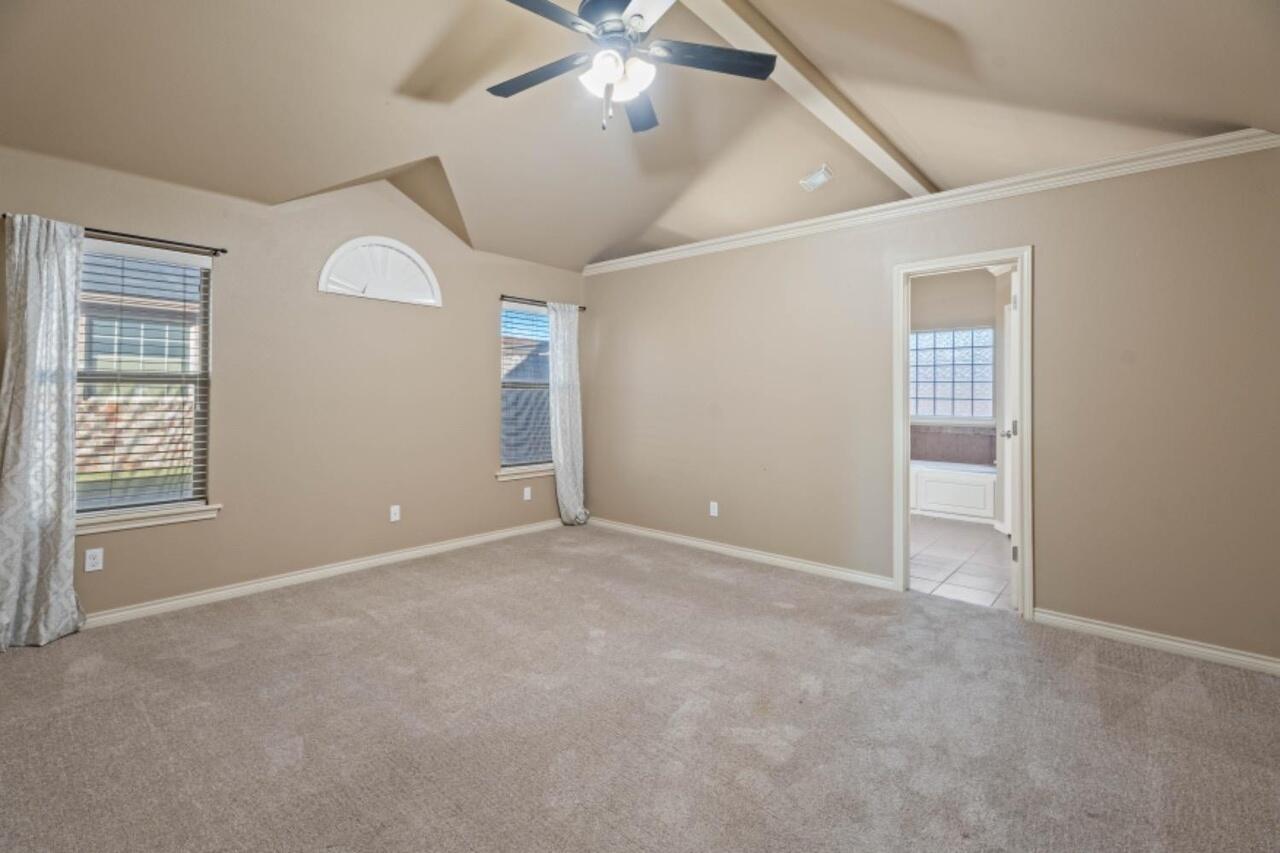6112 101st Street Lubbock, TX 79424 - Photo 8 of 20 an empty room with windows and fan