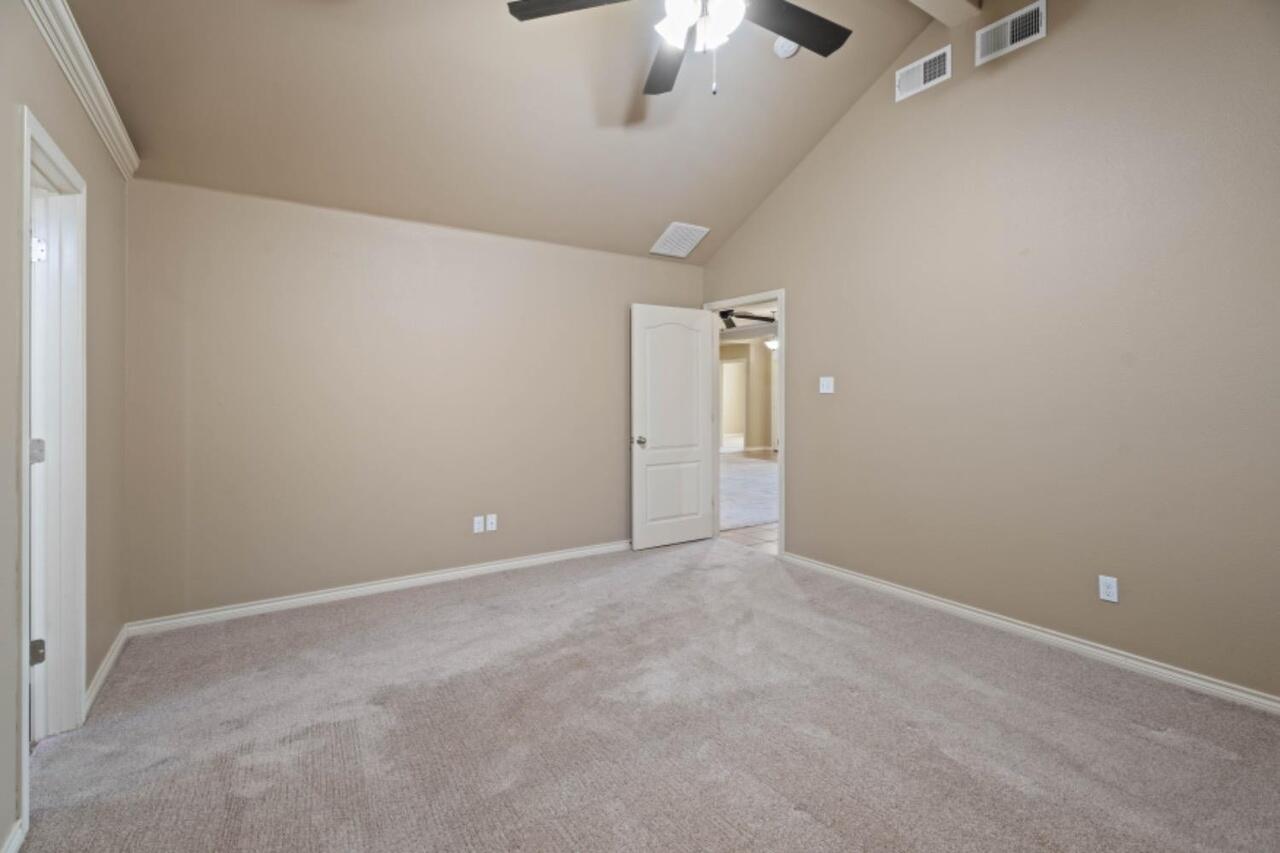 6112 101st Street Lubbock, TX 79424 - Photo 9 of 20 an empty room with a ceiling fan and window