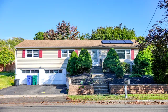 a front view of a house with a garden