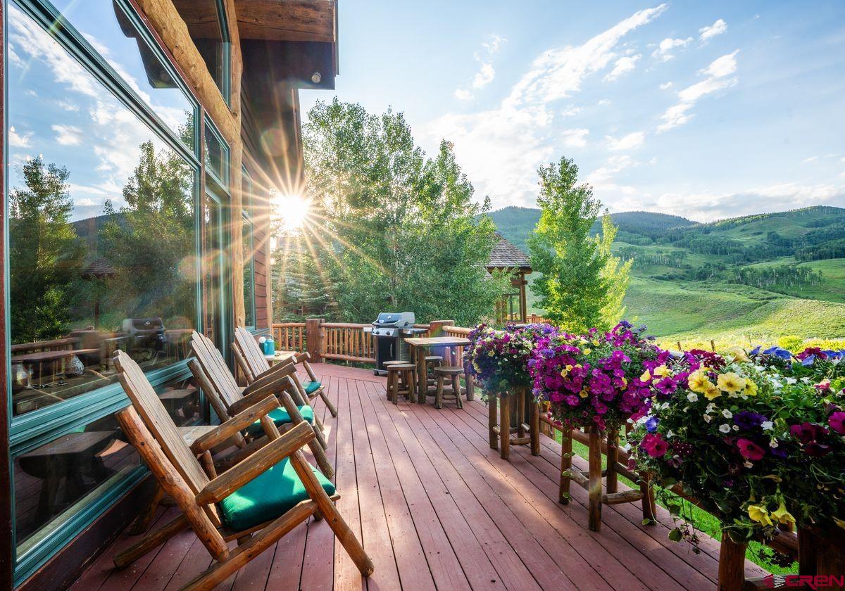 63 Paradise Road Crested Butte, CO 81225 - Photo 5 of 38 a view of a chairs and table in patio with a lake view