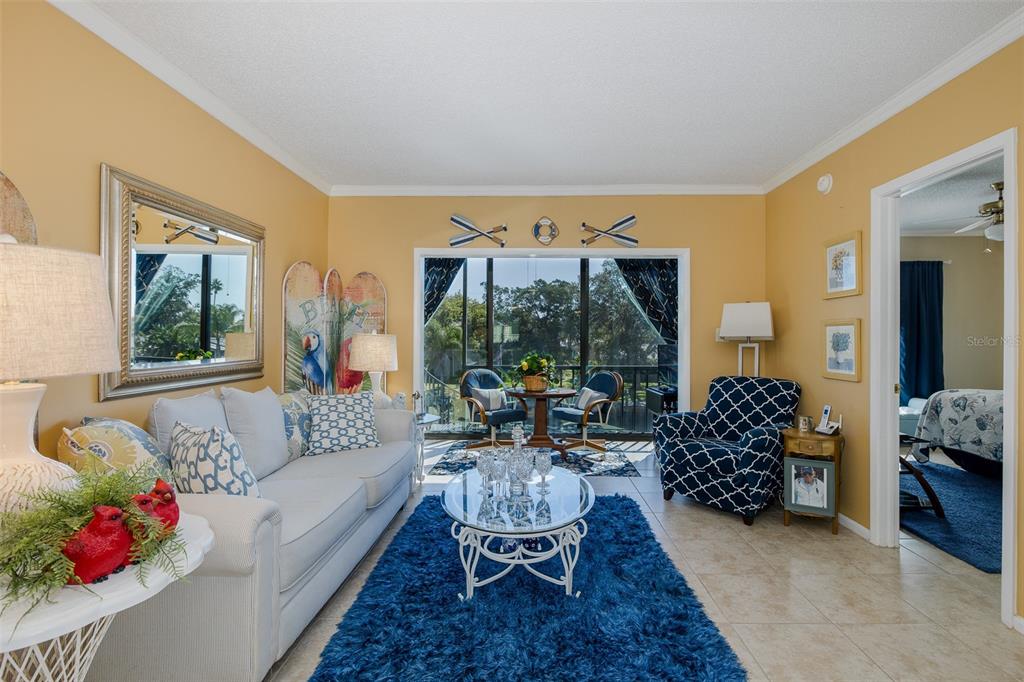 8210 Aquila Street, Unit 213 Port Richey, FL 34668 - Photo 11 of 48 a living room with furniture and a large window