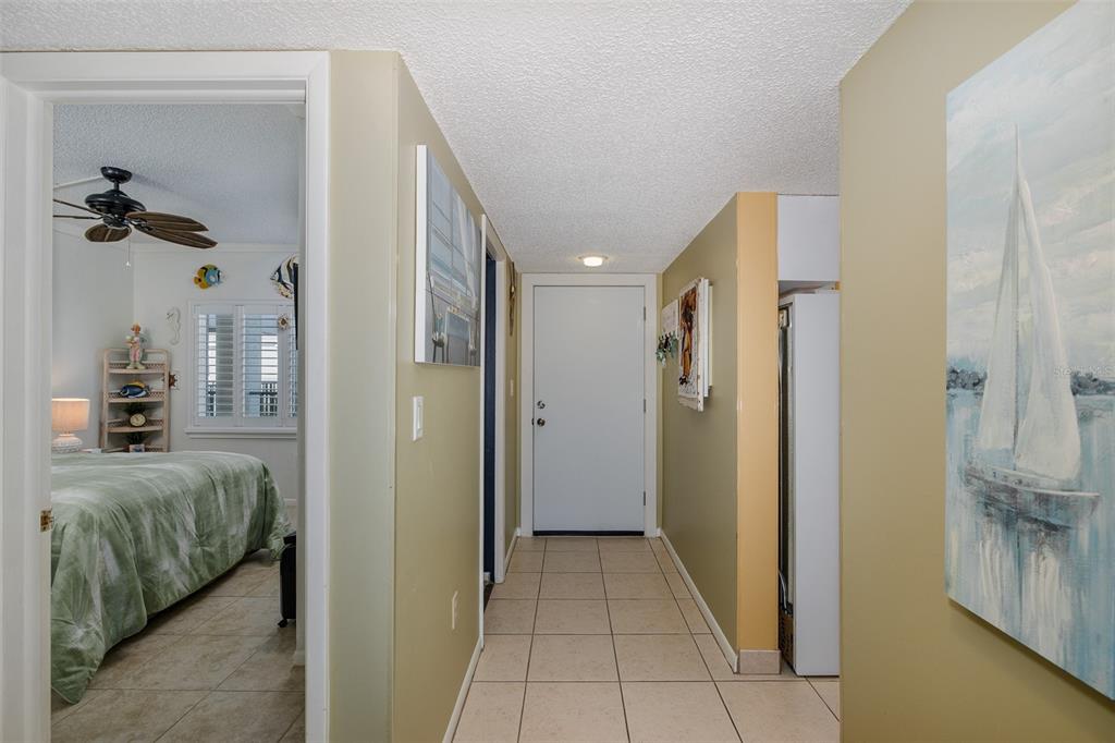 8210 Aquila Street, Unit 213 Port Richey, FL 34668 - Photo 12 of 48 a view of a hallway to a livingroom and a chandelier
