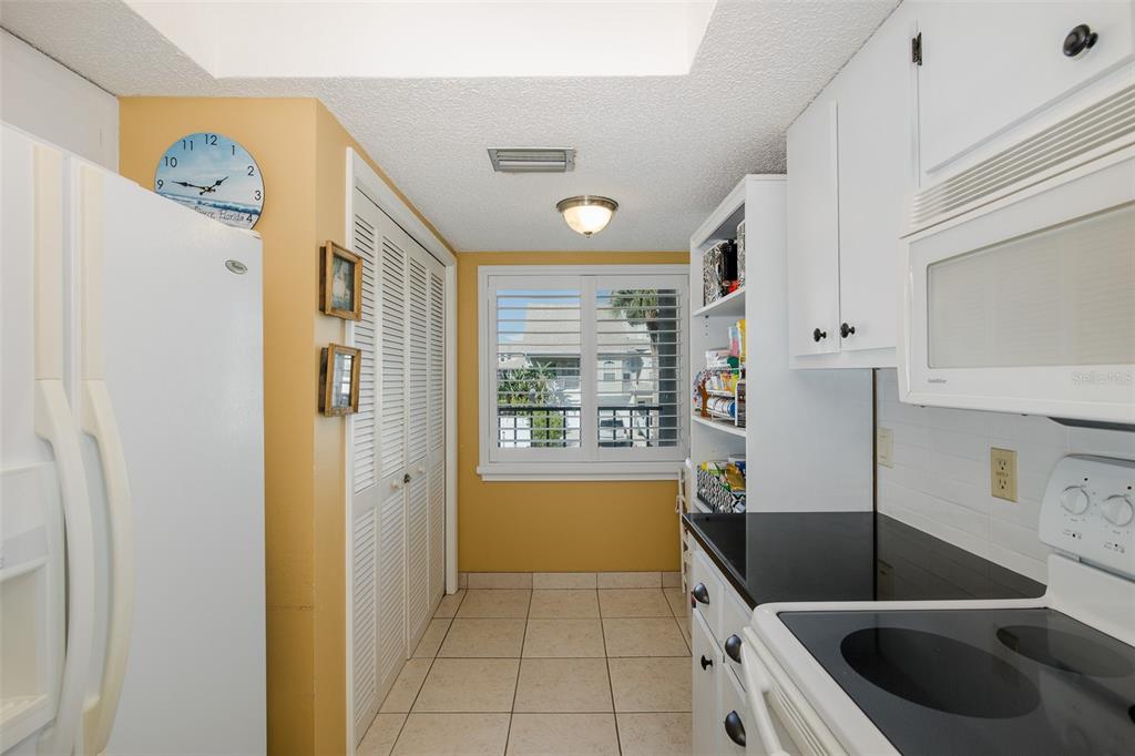 8210 Aquila Street, Unit 213 Port Richey, FL 34668 - Photo 15 of 48 a kitchen with stainless steel appliances granite countertop a sink and a refrigerator