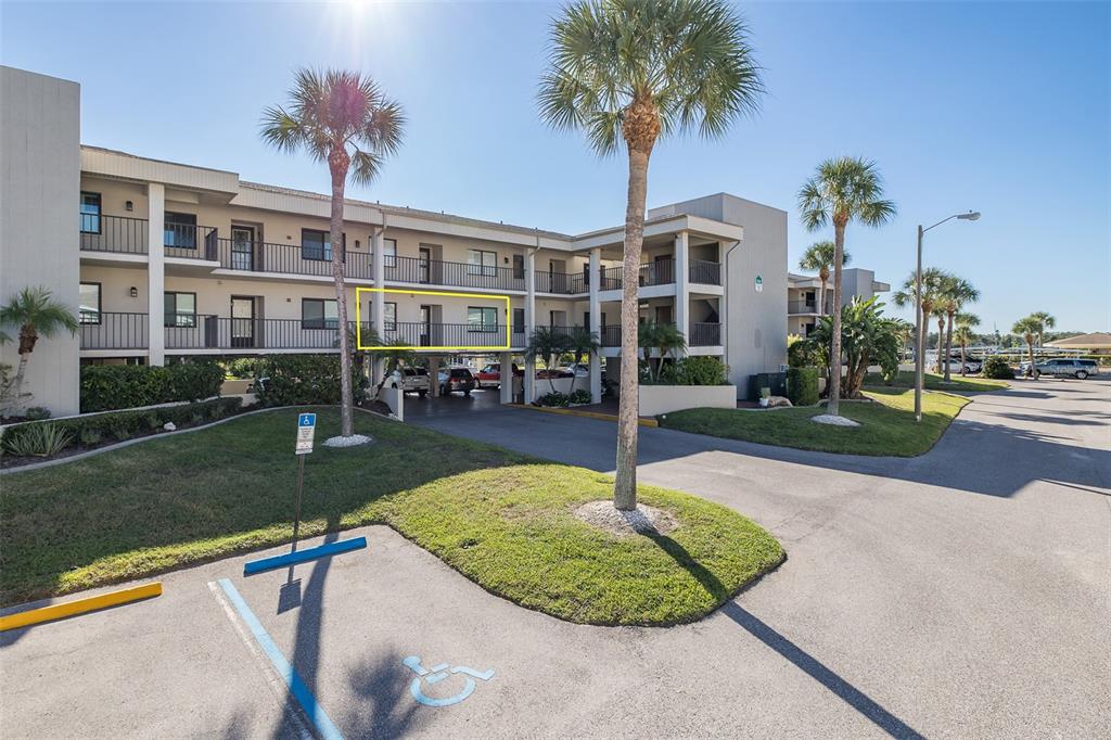 8210 Aquila Street, Unit 213 Port Richey, FL 34668 - Photo 2 of 48 a front view of a house with garden