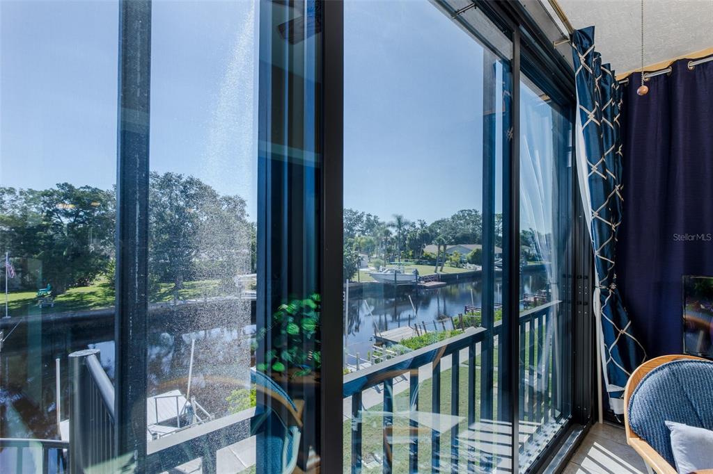 8210 Aquila Street, Unit 213 Port Richey, FL 34668 - Photo 21 of 48 a view of a balcony with a floor to ceiling window wooden floor and wooden fence