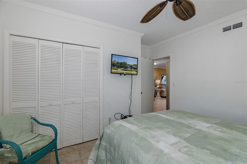 8210 Aquila Street, Unit 213 Port Richey, FL 34668 - Photo 26 of 48 a bedroom with a bed and a chair