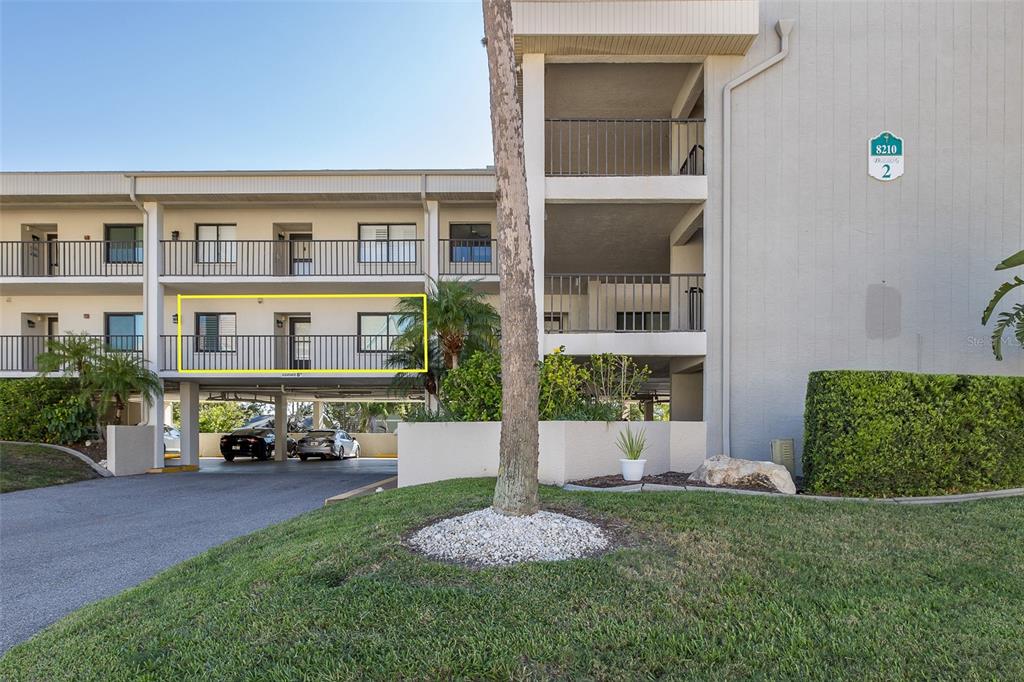 8210 Aquila Street, Unit 213 Port Richey, FL 34668 - Photo 3 of 48 a front view of a house with a yard