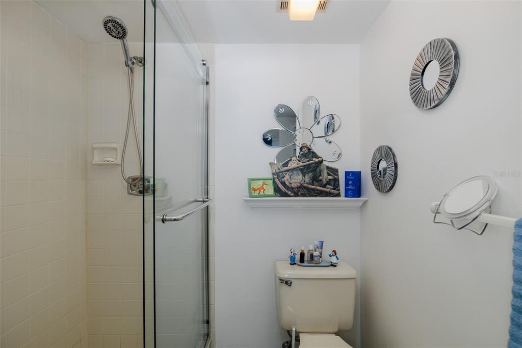8210 Aquila Street, Unit 213 Port Richey, FL 34668 - Photo 31 of 48 a bathroom with a sink a mirror and shower