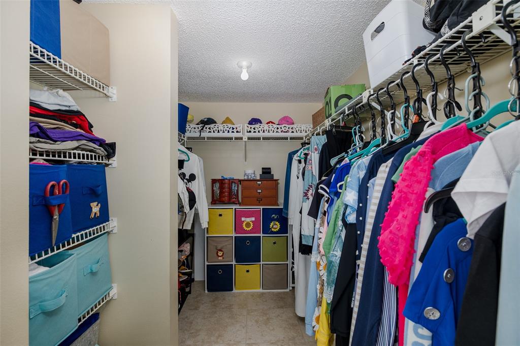 8210 Aquila Street, Unit 213 Port Richey, FL 34668 - Photo 32 of 48 a view of walk in closet with clothes