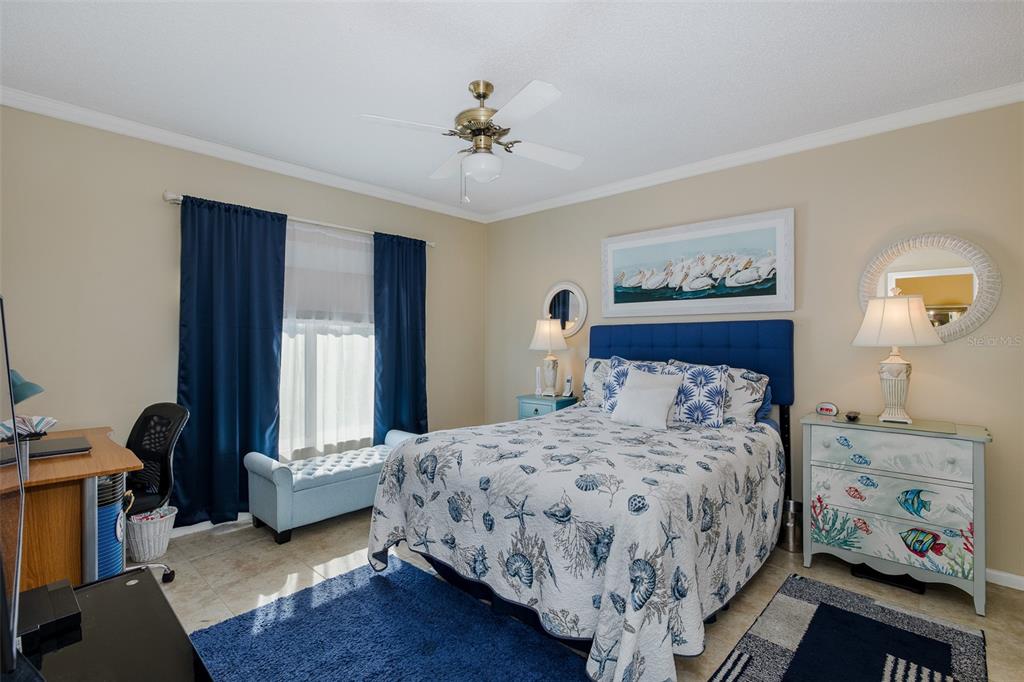8210 Aquila Street, Unit 213 Port Richey, FL 34668 - Photo 33 of 48 a bedroom with a bed and a chandelier