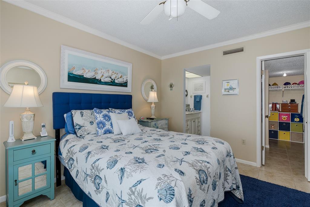 8210 Aquila Street, Unit 213 Port Richey, FL 34668 - Photo 34 of 48 a bedroom with a bed and a chandelier