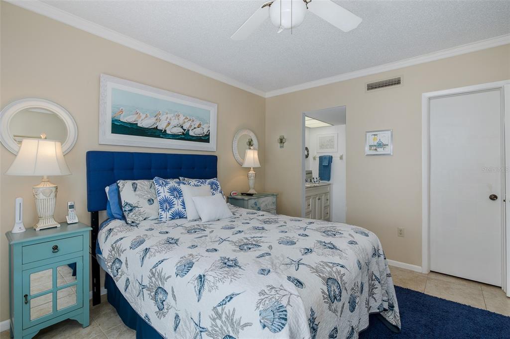 8210 Aquila Street, Unit 213 Port Richey, FL 34668 - Photo 35 of 48 a bedroom with a bed and a painting on the wall