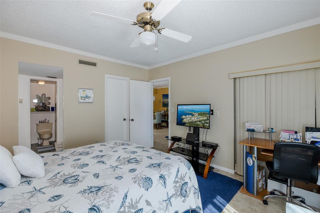 8210 Aquila Street, Unit 213 Port Richey, FL 34668 - Photo 36 of 48 a bedroom that has a bed and a table in it