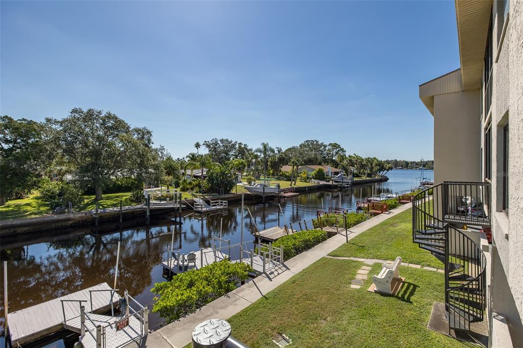 8210 Aquila Street, Unit 213 Port Richey, FL 34668 - Photo 37 of 48 a view of a lake with a house in the background