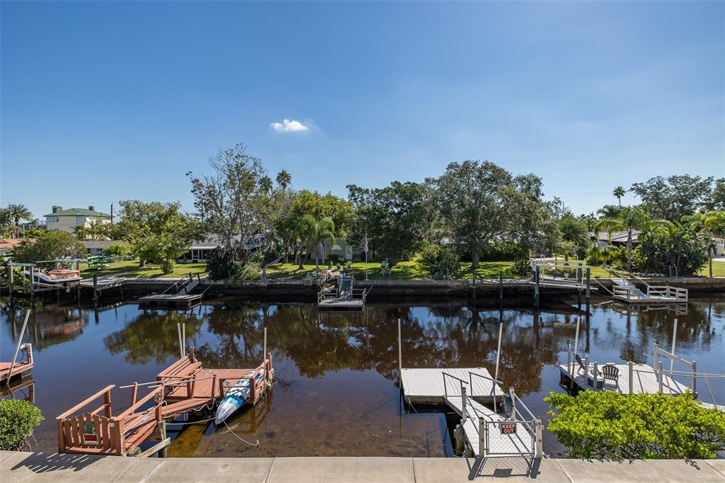 8210 Aquila Street, Unit 213 Port Richey, FL 34668 - Photo 40 of 48 a lake view with boat and trees in the background