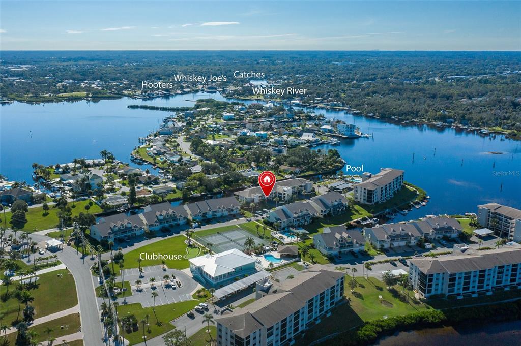 8210 Aquila Street, Unit 213 Port Richey, FL 34668 - Photo 43 of 48 an aerial view of lake and residential houses with outdoor space