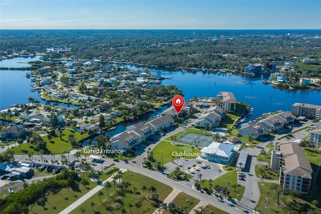 8210 Aquila Street, Unit 213 Port Richey, FL 34668 - Photo 44 of 48 an aerial view of lake and residential houses with outdoor space