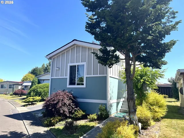a front view of a house with a yard and outdoor seating