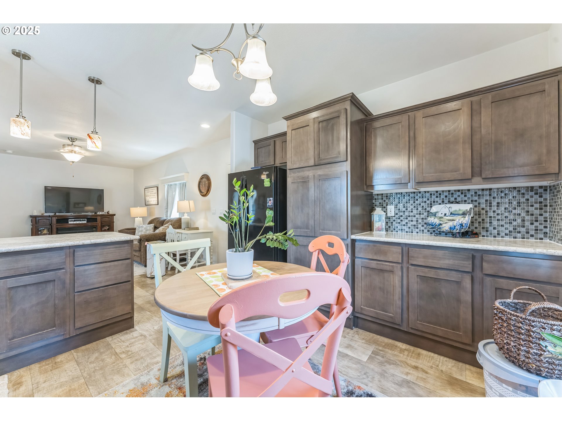 1999 Jansen Way, Unit 29 Woodburn, OR 97071 - Photo 15 of 33 a open kitchen with stainless steel appliances kitchen island granite countertop a sink a stove a dining table and chairs