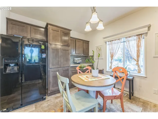 a kitchen with stainless steel appliances granite countertop a refrigerator and a wooden cabinets