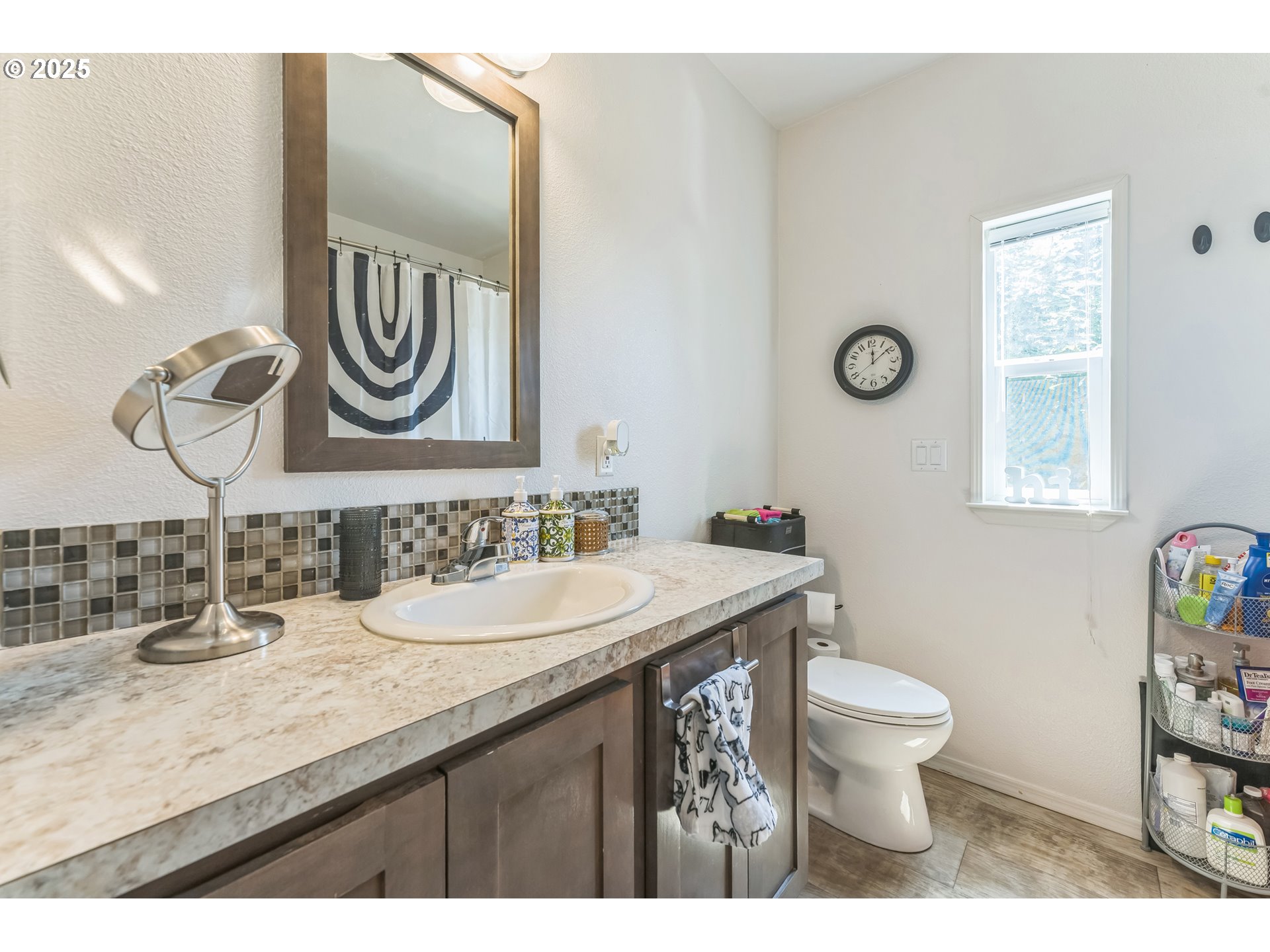 1999 Jansen Way, Unit 29 Woodburn, OR 97071 - Photo 29 of 33 a bathroom with a granite countertop toilet sink and mirror
