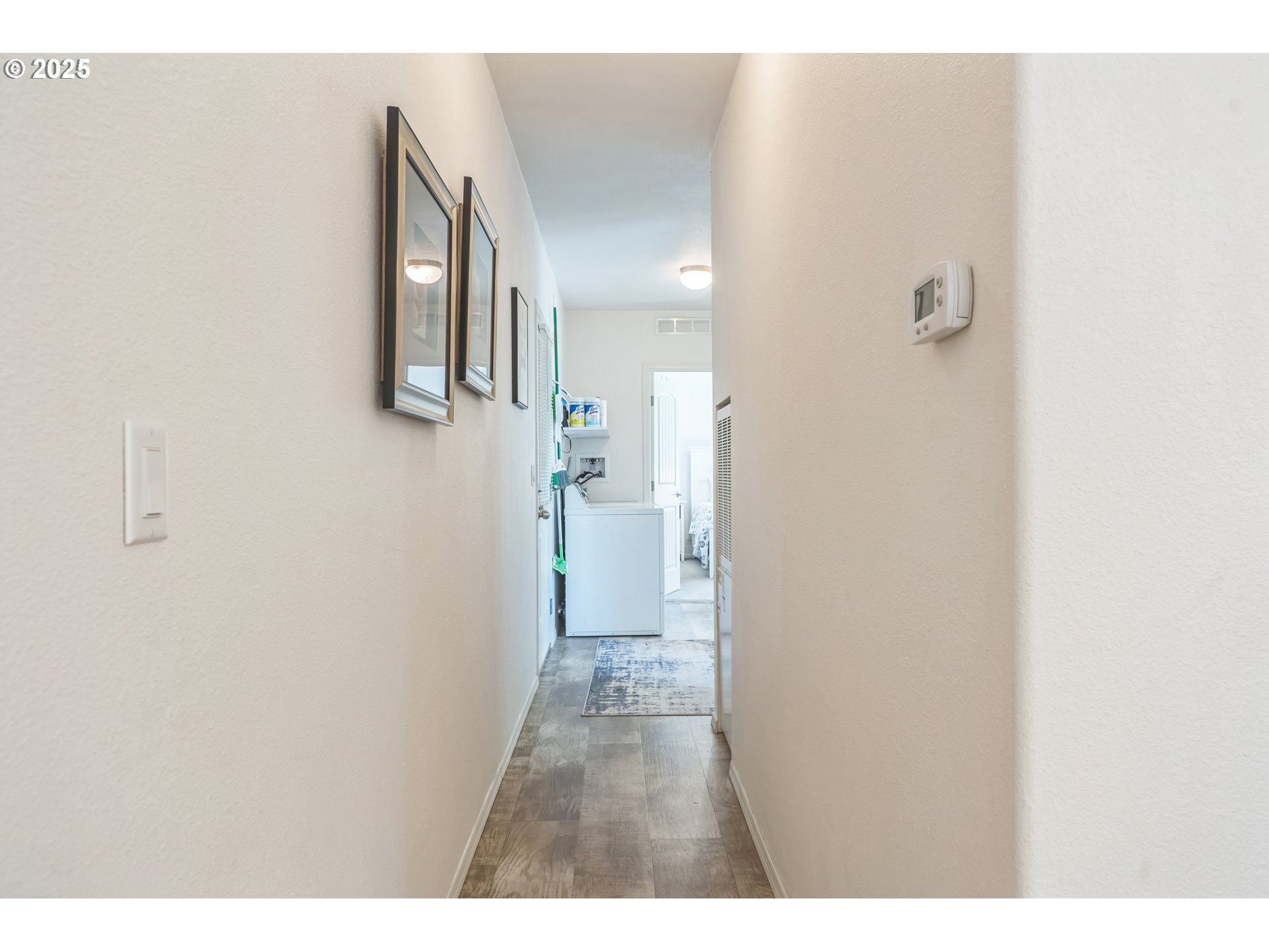 1999 Jansen Way, Unit 29 Woodburn, OR 97071 - Photo 30 of 33 a view of a hallway with wooden floor and a bathroom
