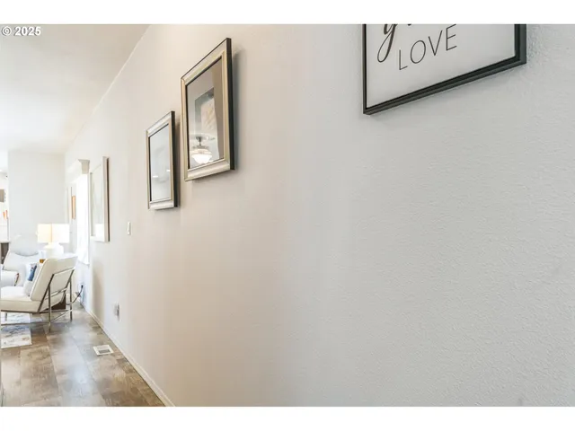 a kitchen with a refrigerator and white cabinets