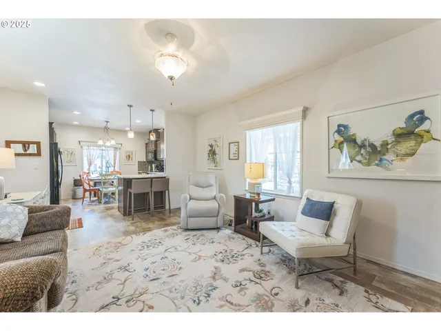 a living room with furniture and kitchen view