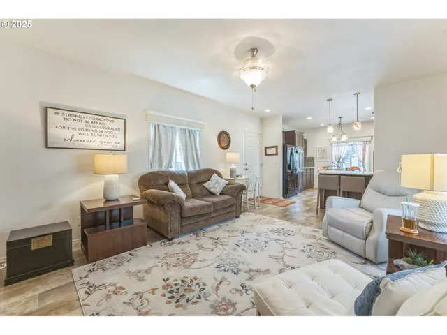 a living room with furniture and a dining table
