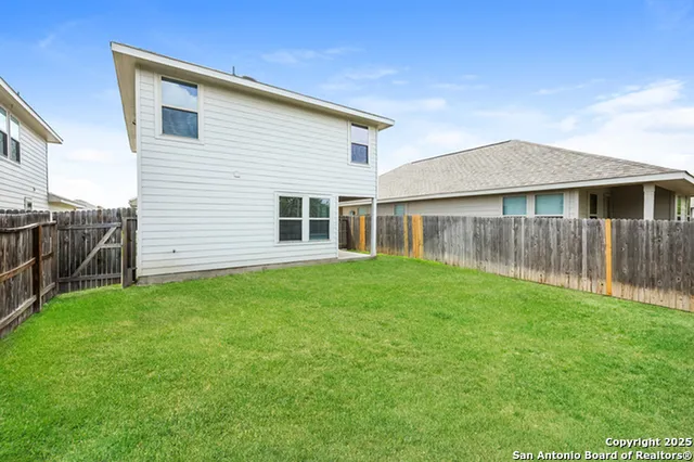 a view of a house with a backyard