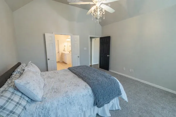 a bedroom with a bed and a chandelier